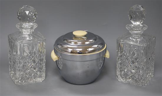 A pair of cut glass spirit decanters and a 1950s ice bucket